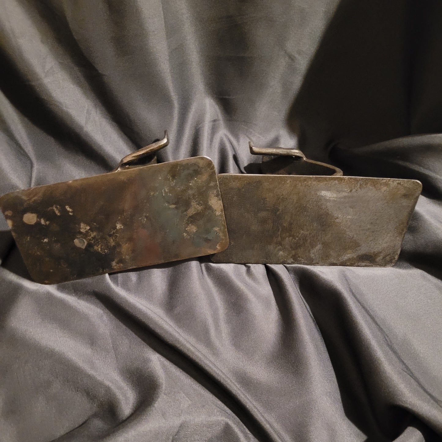 Unteransicht der massiven Höller Buchstützen aus Eisen. Die Ansicht verdeutlicht die schwere Ausführung und die authentische Patina des Metalls, welche den Vintage-Charakter und die Langlebigkeit dieser Designobjekte unterstreicht.