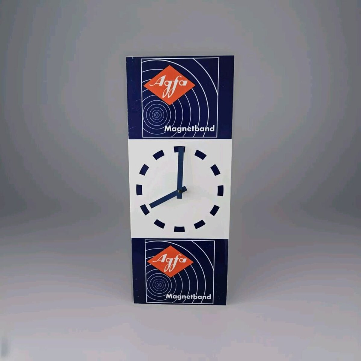 Agfa - Magnetband Werbung Uhr -Retro-Wanduhr mit dem markanten roten Agfa-Logo und blauem Magnetband-Design. Weißes Zifferblatt mit blauen Markierungen und Zeigern. Nostalgische Uhr, die an die Ära der Magnetbänder erinnert und für Liebhaber von Retro-Technologie und Design interessant ist.
