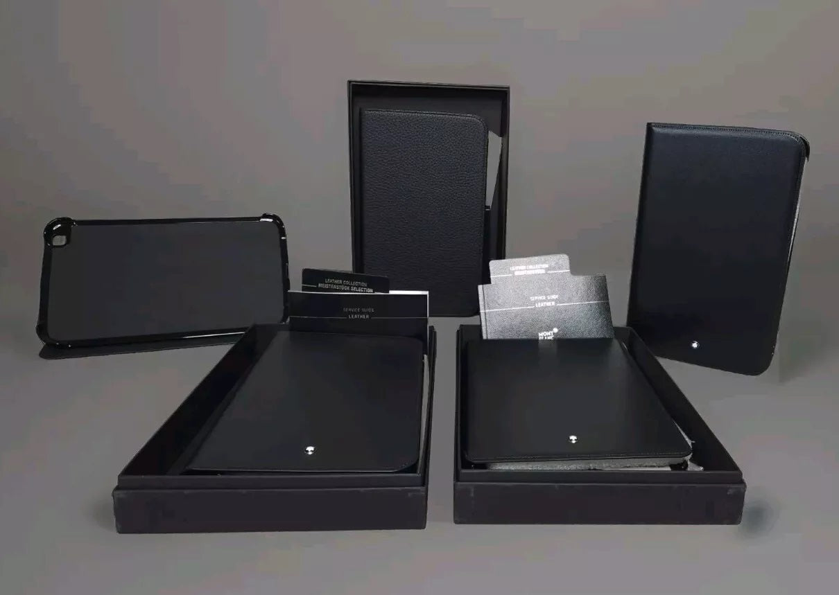 Fünf elegante Montblanc Tablet-Schutzhüllen aus Leder in verschiedenen Positionen und Verpackungen.