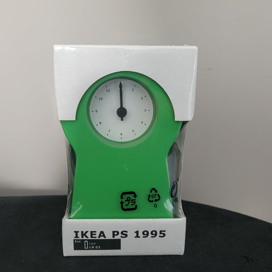 Die Ikea PS 1995 Schlüsselloch Design Thomas Eriksson Vintage Standuhr steht elegant auf einem dunklen Untergrund. Ihr einzigartiges Schlüsselloch-Design verleiht ihr einen besonderen Vintage-Charme, während die klare Formensprache klassische Ästhetik mit moderner Funktionalität kombiniert. Ein echtes Sammlerstück für Liebhaber von Vintage-Design!