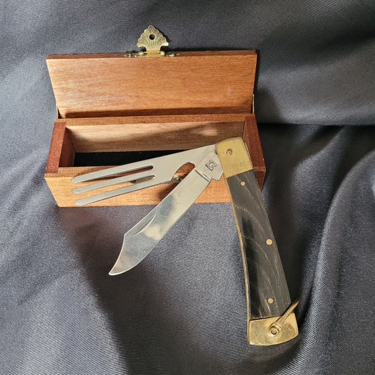 Zweiteiliges rustikales Jagdmesser-Set von Ochsenkopf mit Schalen in Horn-Optik, Messerklinge, Gabel und Kapselheber, in einer passenden Holzschatulle.