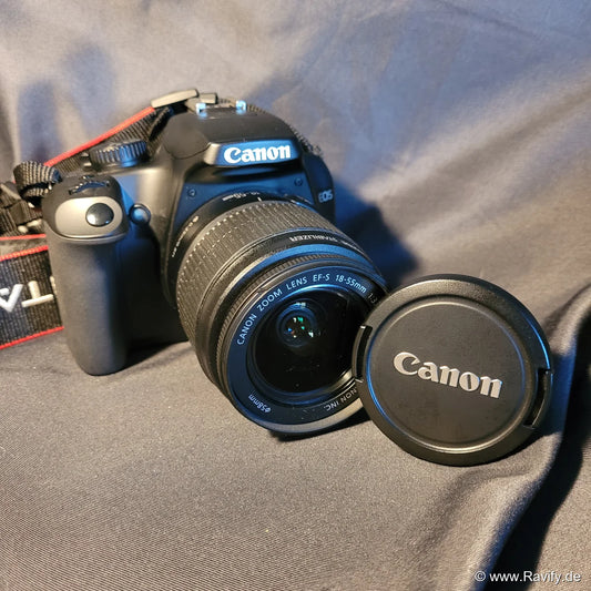 Canon EOS 1000D DLSR-Kamera mit angesetztem Canon Zoom-Objektiv, inklusive Kameratasche, Akku, Ladegerät und 8GB Speicherkarte.