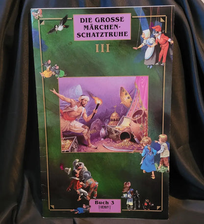 Das Cover des Buches 'Die Große Märchenschatztruhe III' mit verschiedenen Märchenfiguren auf grünem Hintergrund.